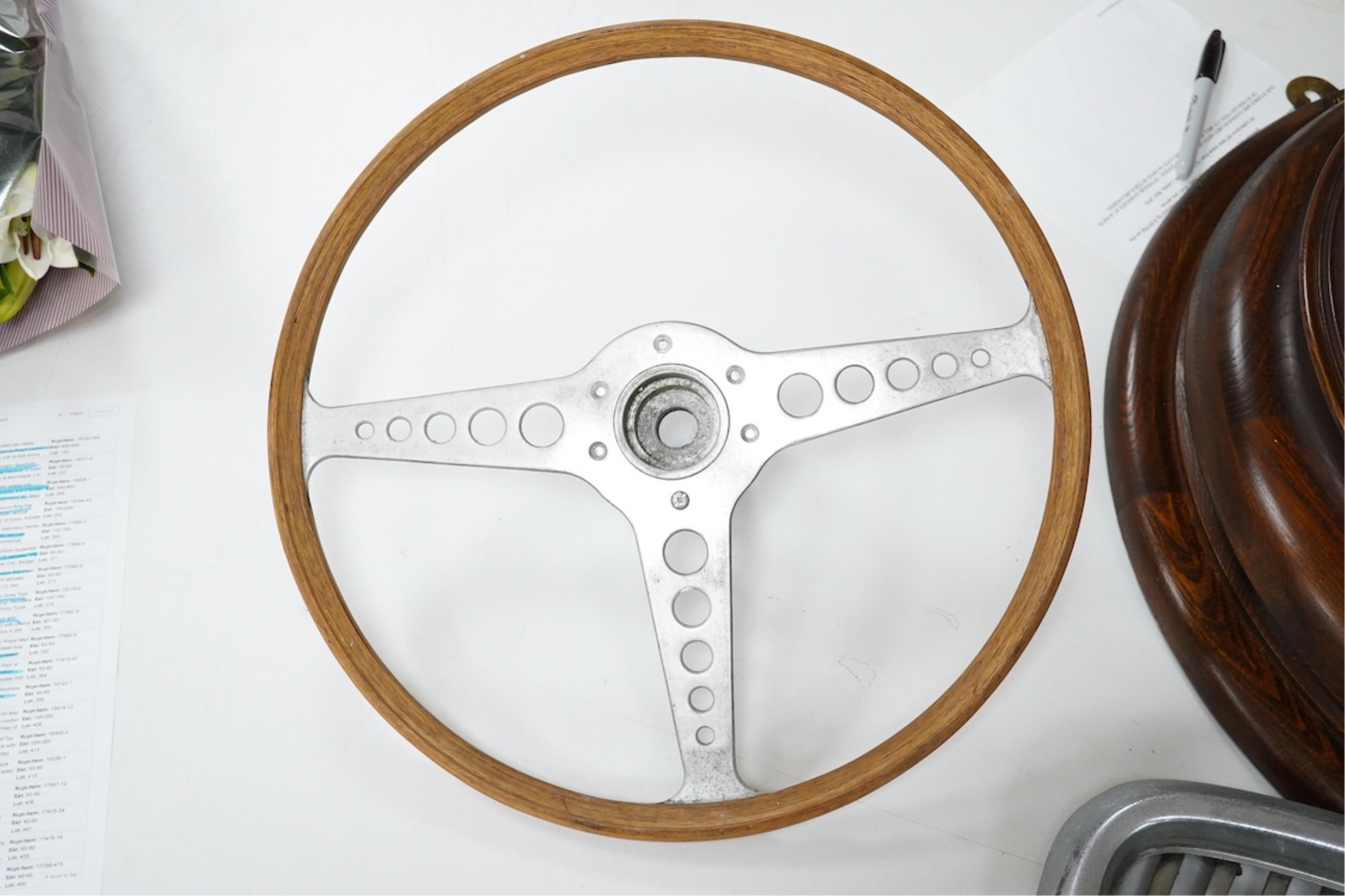 A Jaguar E Type steering wheel in wood and steel, together with the top section of the steering column which bolts to the steering wheel, missing the central Jaguar emblem, 41cm diameter